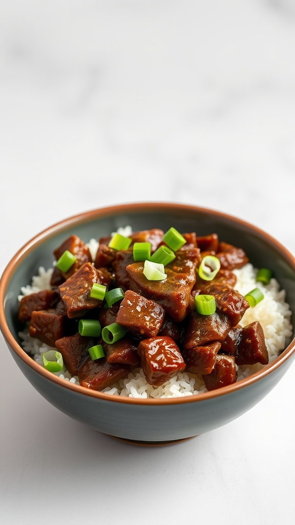 A bowl of Mongolian beef served over rice, garnished with green onions.